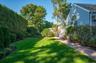 Mature trees and vibrant greenery transform this outdoor space into a serene sanctuary.