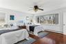 Bedroom featuring ceiling fan, dark wood-type flooring, and baseboard heating