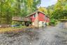 View of deck off kitchen and wide driveway for plenty of parking.