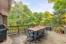 Rear deck is ideal for entertaining, or simply to unwind. There's a staircase that leads to the garden and yard.