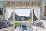 sunlit living area with large picturesque windows