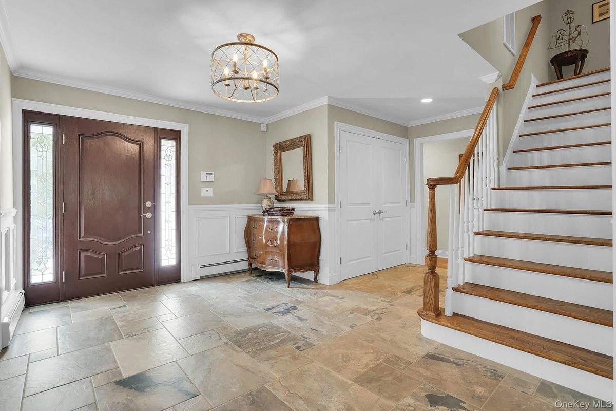 Gorgeous entry door and stne flooring.