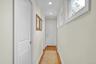 Hallway leads to 2 walk-in-closets and primary bathroom.