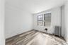 Spare room featuring radiator heating unit and wood finished floors