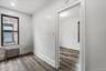 Unfurnished room featuring radiator and wood finished floors
