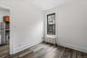 Unfurnished room featuring radiator and dark wood finished floors