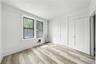 Unfurnished bedroom with radiator, light wood finished floors, and recessed lighting