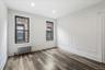 Spare room with radiator, wood finished floors, recessed lighting, and a decorative wall