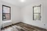 Spare room featuring radiator heating unit and wood finished floors