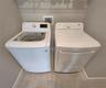 Interior Laundry Room includes side-by-side washer and dryer, ventilated shelves, and storage space