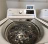 Interior Laundry Room includes side-by-side washer and dryer, ventilated shelves, and storage space