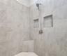 Master bathroom includes large walk-in  tiled shower, water closet, walk-in closet, dual sink vanity, granite countertops