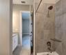 Jack-n-Jill Bathroom includes separate sink vanities, bathtub/shower combo