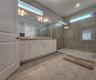 Master bathroom includes large walk-in  tiled shower, water closet, walk-in closet, dual sink vanity, granite countertops