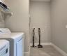 Interior Laundry Room includes side-by-side washer and dryer, ventilated shelves, and storage space