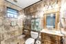 Large-format tile flooring, recessed ceiling lighting, and a neutral color palette