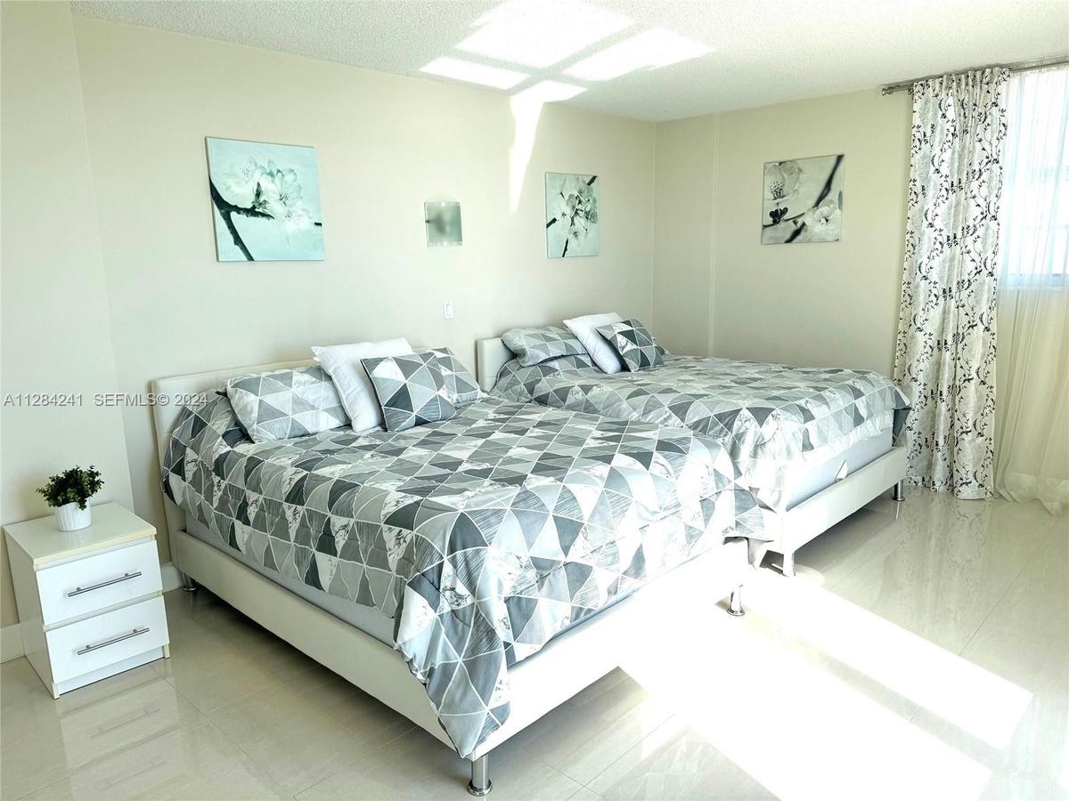 Main bedroom with Direct east ocean/beach view. 2 queen beds