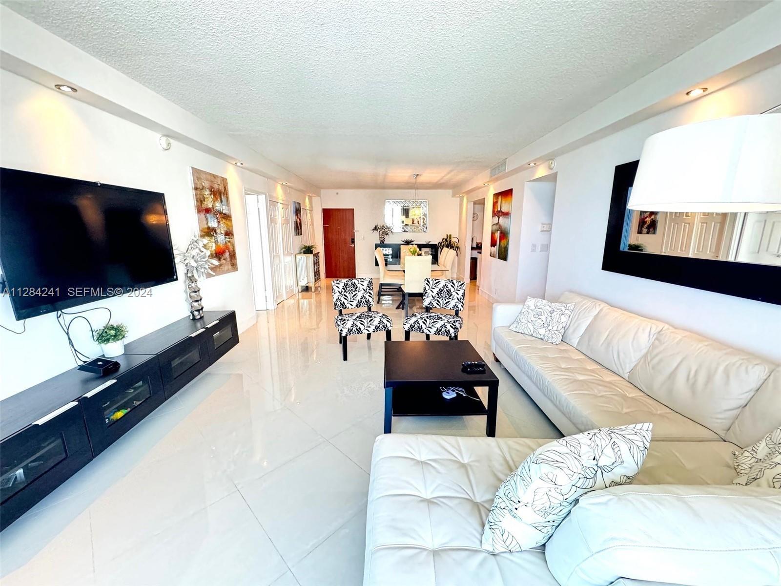 white leather sect sofa, Large Flat TV, upscale furnished