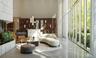 Lobby featuring floor-to-ceiling windows with metal framing, stone-finish reception desk, custom built-in wood shelving, and polished concrete floorin