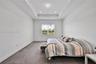 Neutral-toned wall-to-wall carpeting, recessed ceiling lighting, and a glass-paned sliding door providing exterior access