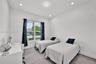 Neutral interior featuring wall-to-wall carpeting, recessed ceiling lighting, and a double-pane window with installed blinds