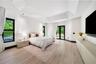 Vaulted ceiling featuring recessed lighting, wood-finish flooring, and black-framed windows with double-door exterior access