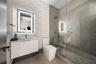 Bedroom featuring textured accent wall, floor-to-ceiling windows, recessed lighting, and wood-finish flooring