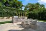 Exterior featuring a stucco facade, tile roof, swimming pool with stone decking, and an integrated putting green