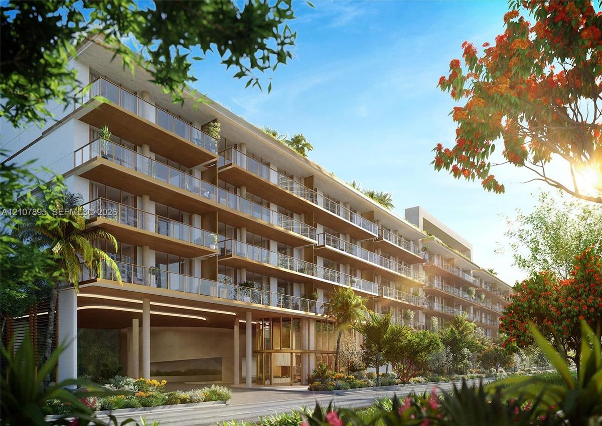 Multi-story modern building featuring expansive private balconies, glass railings, wood-toned soffits, and a covered ground-level porte-cochère with i