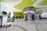 Fitness center featuring expansive floor-to-ceiling windows, high-contrast patterned ceiling, curved corrugated-metal structural accents, and large-fo