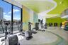 Fitness facility featuring floor-to-ceiling windows, specialized patterned ceiling treatment, corrugated wall cladding, and recessed lighting