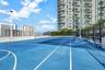 Outdoor tennis court featuring a blue hard-surface finish, perimeter chain-link fencing, court lighting, and painted lines