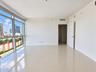 Floor-to-ceiling windows, large-format tile flooring, and a single-panel interior door