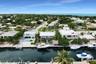 Waterfront residential property featuring a private boat dock, tiki-style structure, and metal roof system