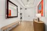 Entryway featuring double doors, wood-finish flooring, a recessed ceiling tray, and a linear geometric light fixture