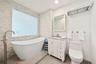 Primary Bathroom with shower and separate soaking tub. Switchable privacy glass