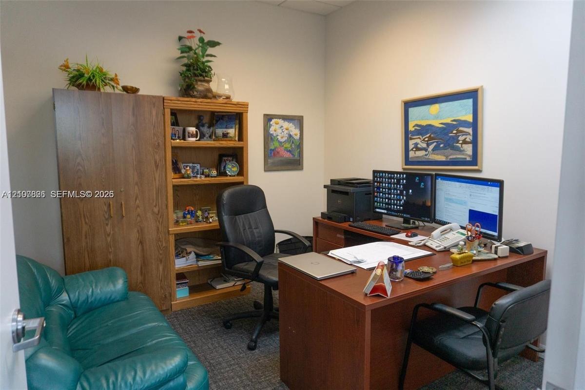 Room featuring built-in wood-finish cabinetry, integrated shelving, and carpeted flooring
