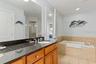 Primary ensiut bathroom with large soaking tub, walk in shower, and private water closet.