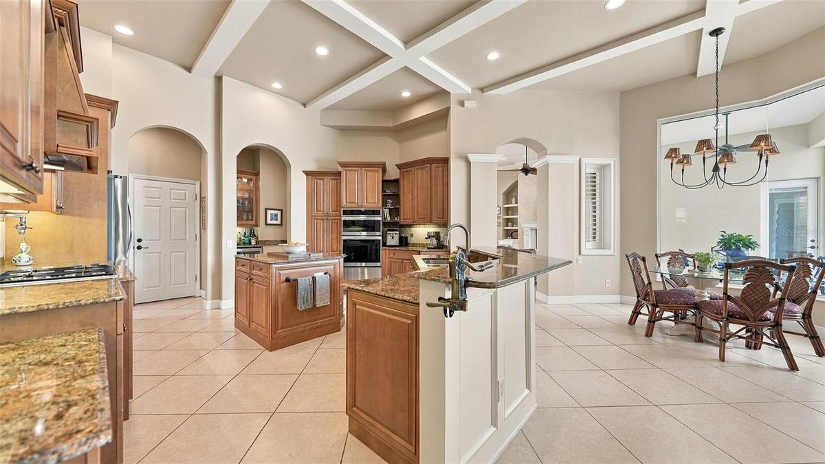 A generous breakfast area invites leisurely mornings, with an aquarium-style window framing picturesque outdoor views.