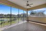 The screen enclosed balcony affords panoramic views that extend well beyond the backyard.