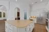 a large central island with an additional prep-sink, walk-in pantry and butler's pantry & bar alcove.