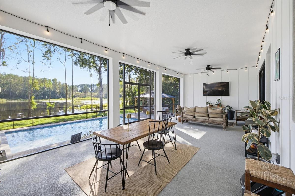 32 FT+ covered, screened, rear porch with TV and fans.
