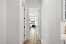 Hallway to primary suite with the laundry room conveniently located next to it.