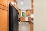 Updated kitchen featuring warm wood cabinetry, a ceramic tile backsplash, and ceramic tile flooring, with beautiful Hudson River views from the window