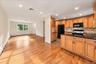 An inviting open floor plan seamlessly connects the kitchen, dining room, and living room, creating a bright and airy space ideal for everyday living 