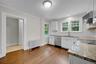 Entranceway leads to half-bath and backdoor hallway