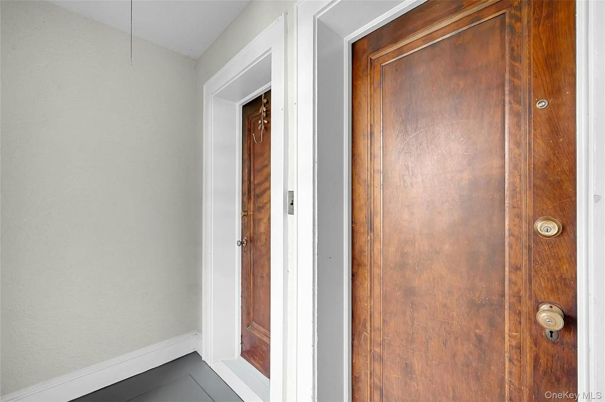 Doorways to the 3-bed duplex on the right/West-side, and the 1-bed first floor unit on the left side