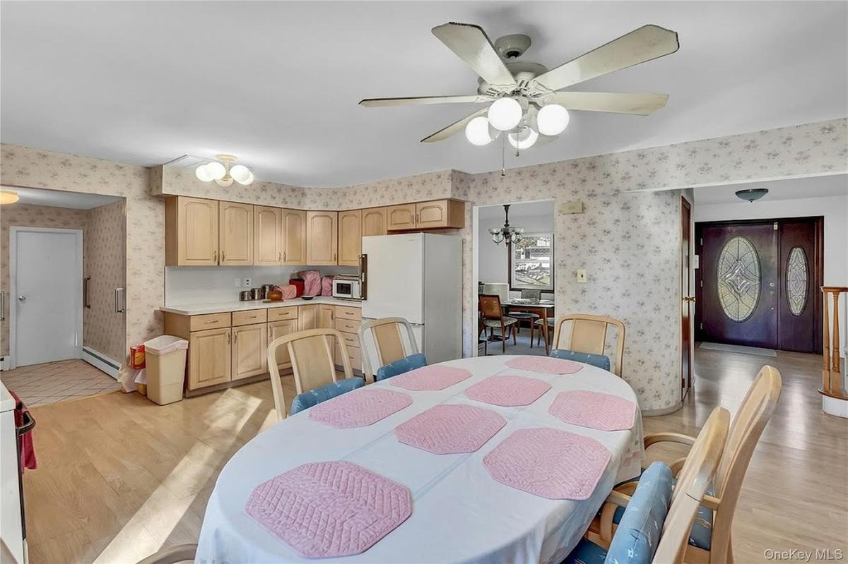 Kitchen featuring wood cabinetry, laminate countertops, and wood-finish flooring
