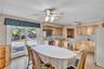 Kitchen featuring light-finish cabinetry, sliding glass doors, wood-finish flooring, and a ceiling-mounted light fixture