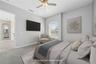 This is bedroom two with an ensuite and walk in closet for your guests or children to enjoy (photo virtually staged).